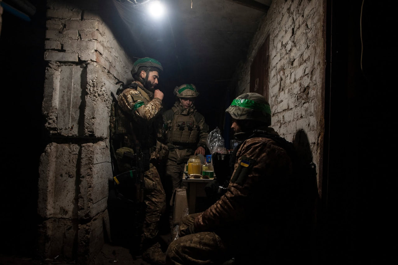 Servicemembers in a narrow brick passage.