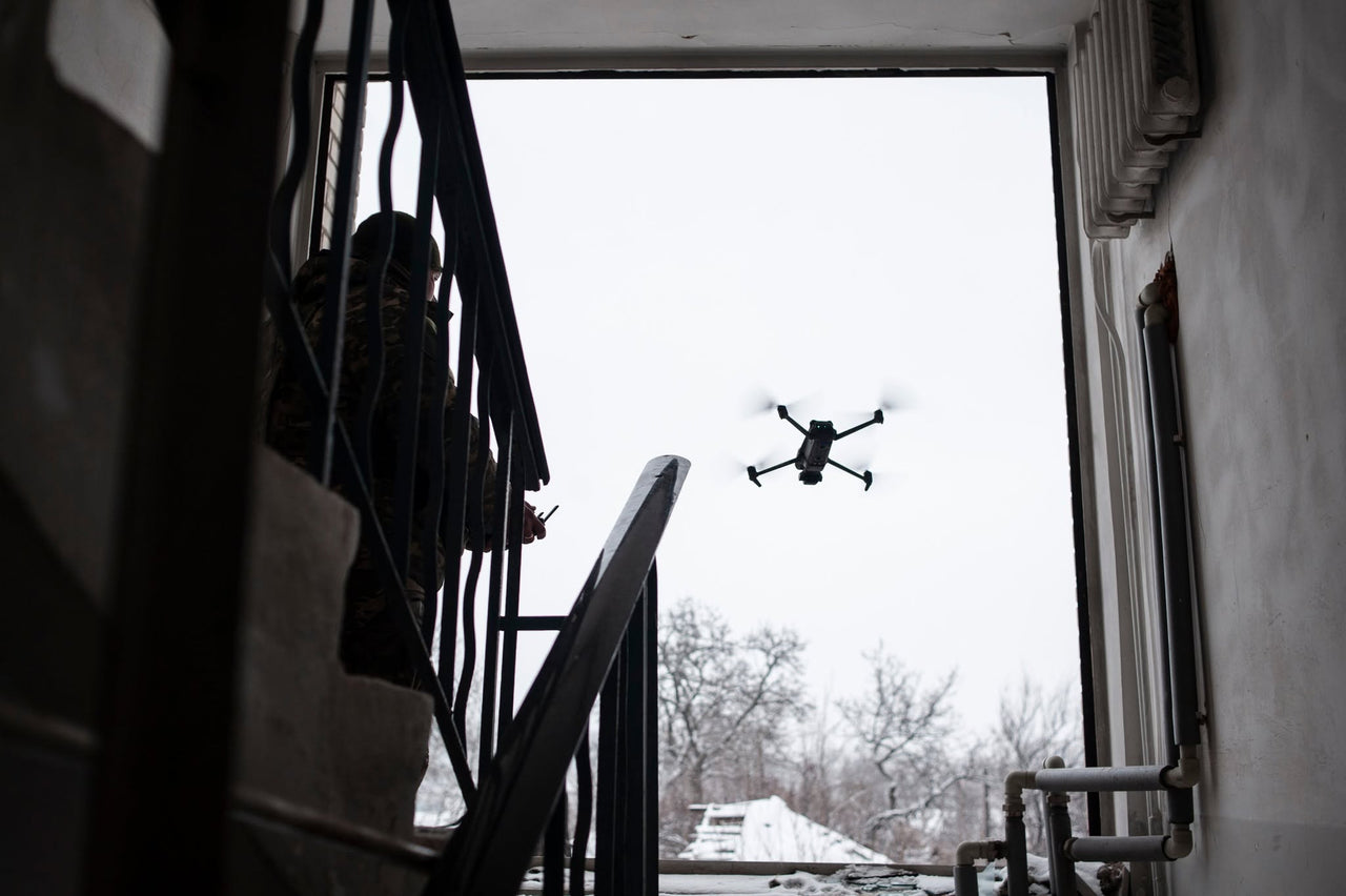 A drone outside a stairwell window.