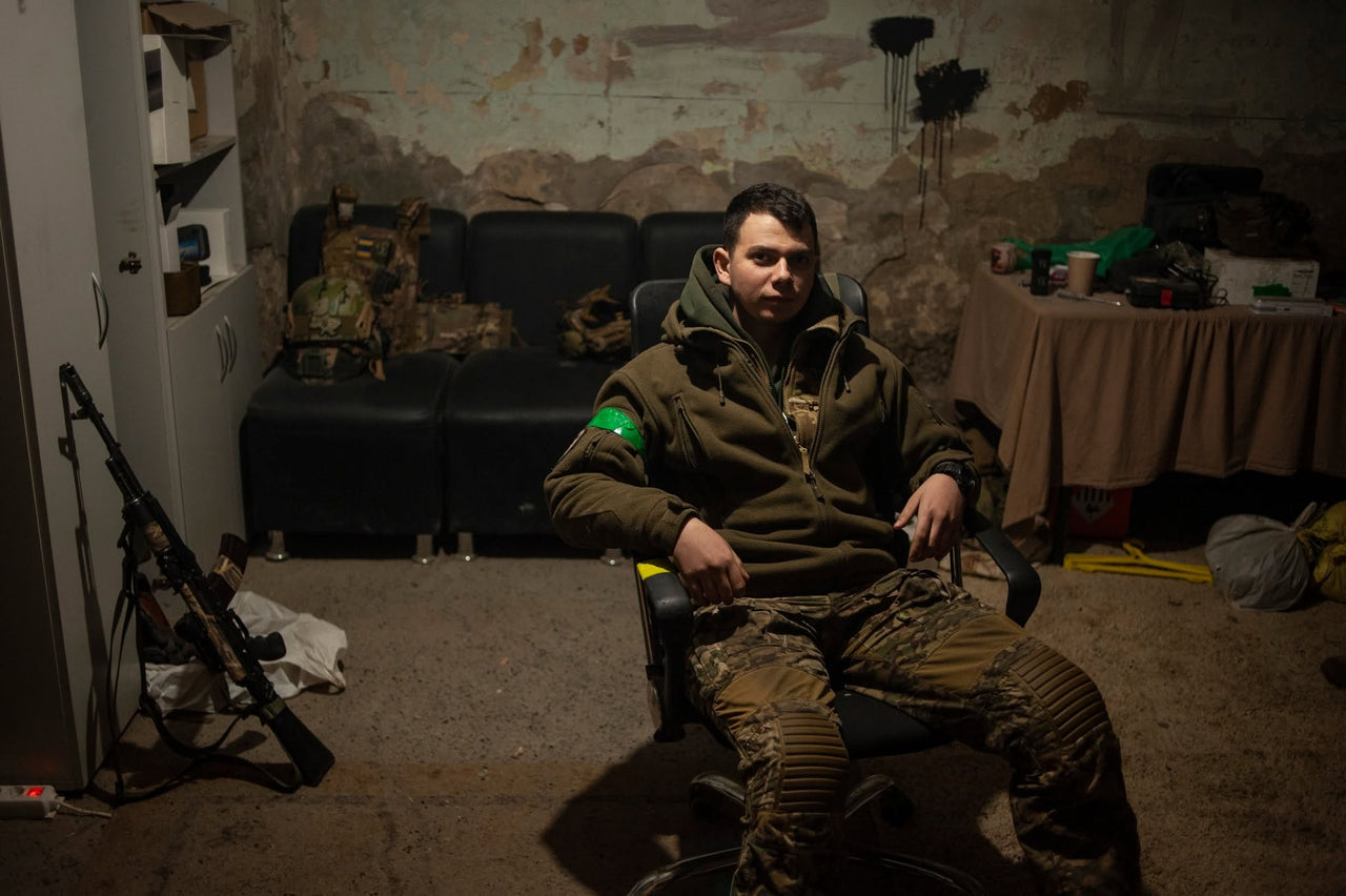 A servicemember sitting during a quiet moment.