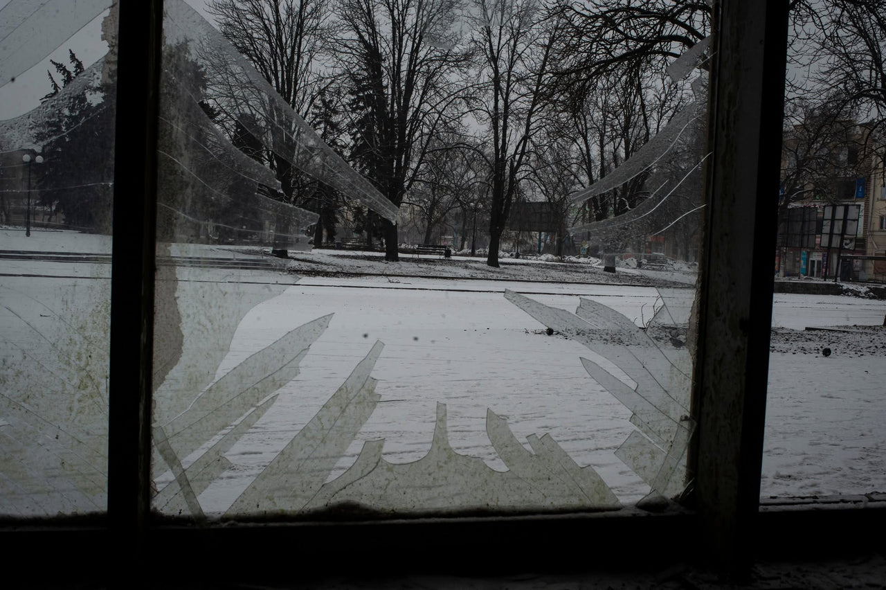 A winter courtyard seen through a window.
